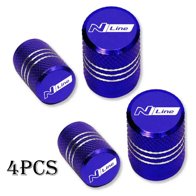 Set of four blue NLine brand aluminum tire valve caps with silver stripes