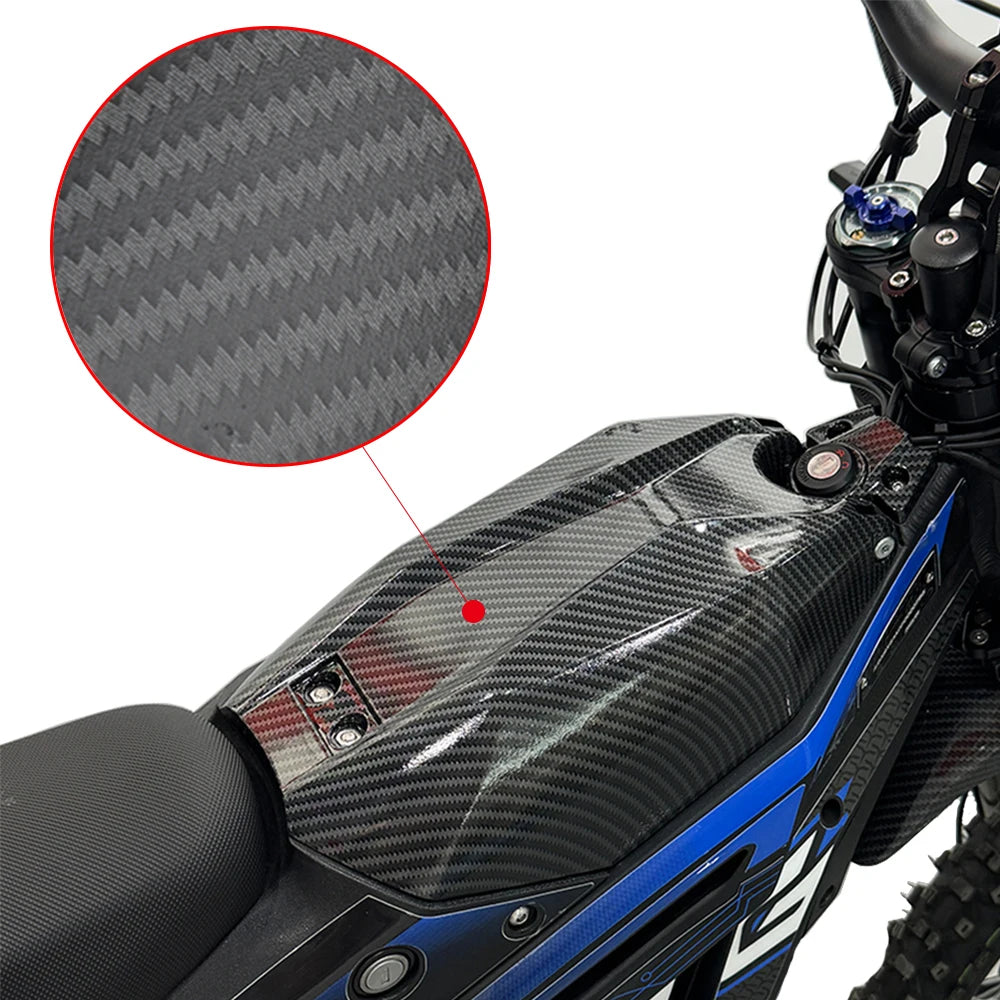 Close-up of a black carbon fiber motorcycle mudguard and protection kit installed on a blue motorcycle.