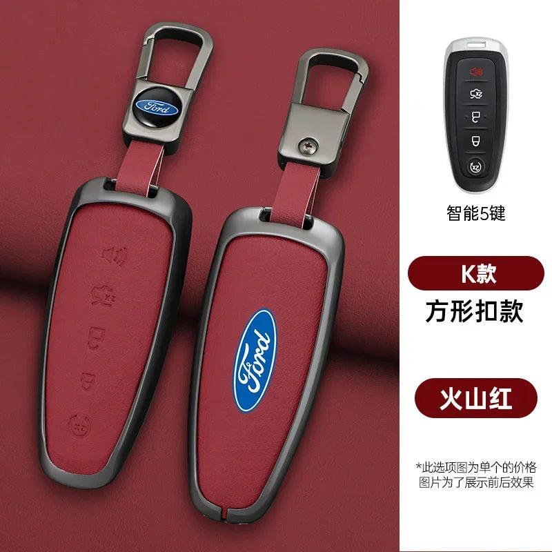 A pair of red leather car key covers with silver metal clasps and Ford logos displayed on a maroon background.