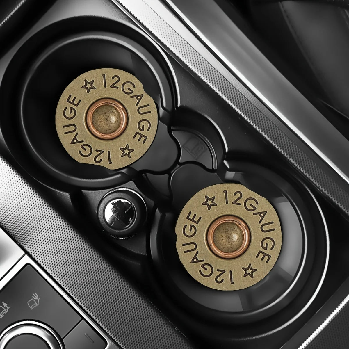 A close-up view of two brass gauge-marked silicone bullet car cup mats inside a vehicle console.