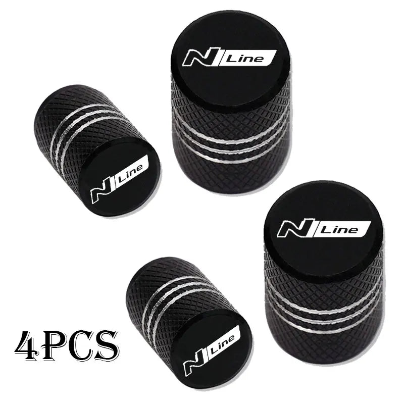 Set of four black N Line CNC aluminum tire valve caps with silver stripes.