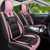 Pink and black leather car seat covers installed in a vehicle interior.