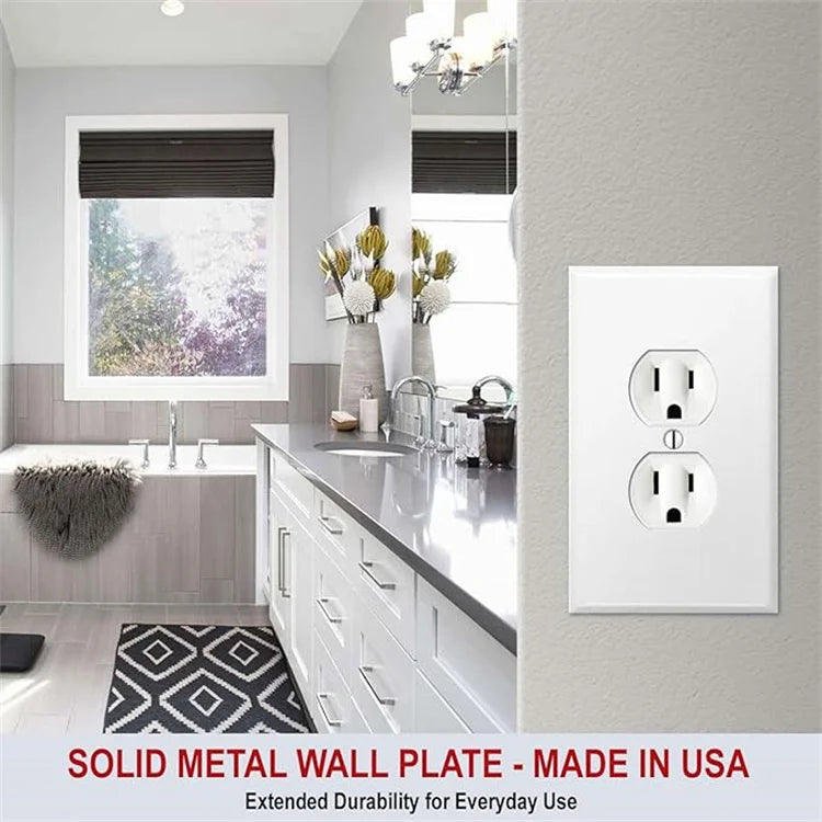 A white solid metal wall plate for an electrical light switch, installed on a gray wall next to a window.