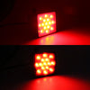 A close-up of a red LED trailer hitch light cover illuminating a surface with a bright red glow.