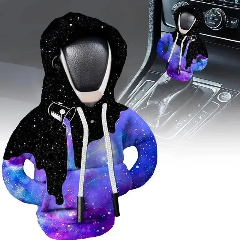 A cozy knit gear shift cover in purple and black with a hood, shown alongside an automotive shifter.