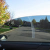A close-up view of a car window with professional heat and UV blocking film installed.