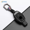 Black carbon fiber car key cover with silver clasp and electronic features