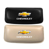 A pair of leather car driving knee pads, one black and one beige, featuring a Chevrolet emblem.