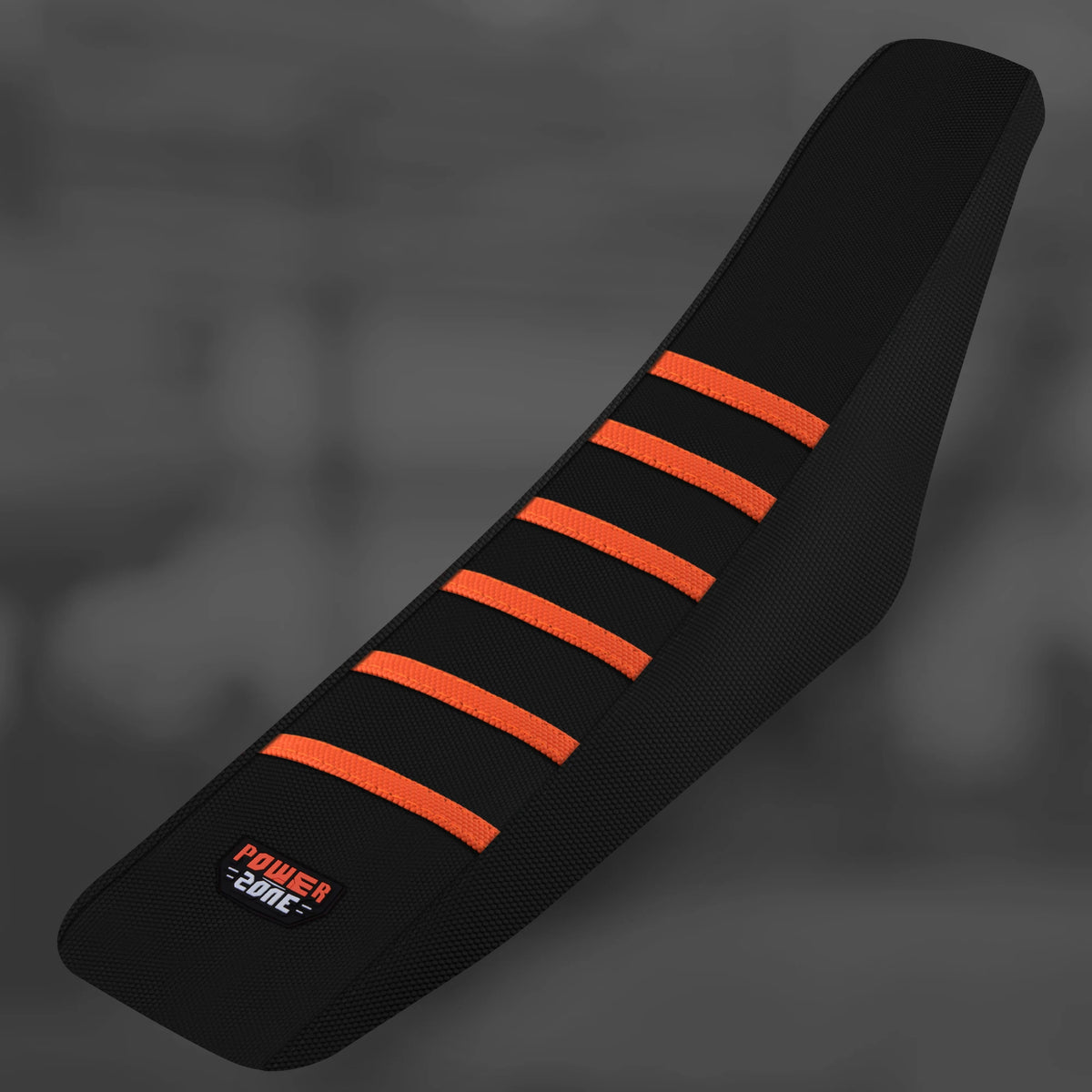 Black motorcycle seat cover with orange stripes on a dark gray background.