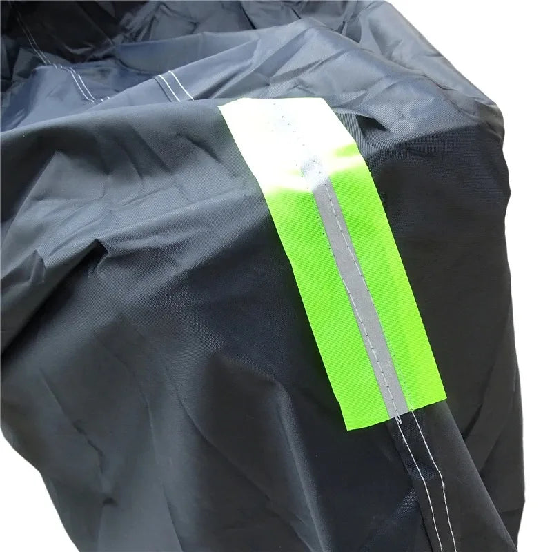 A bright neon yellow waterproof cover for a motorcycle or scooter is shown folded on a dark fabric.