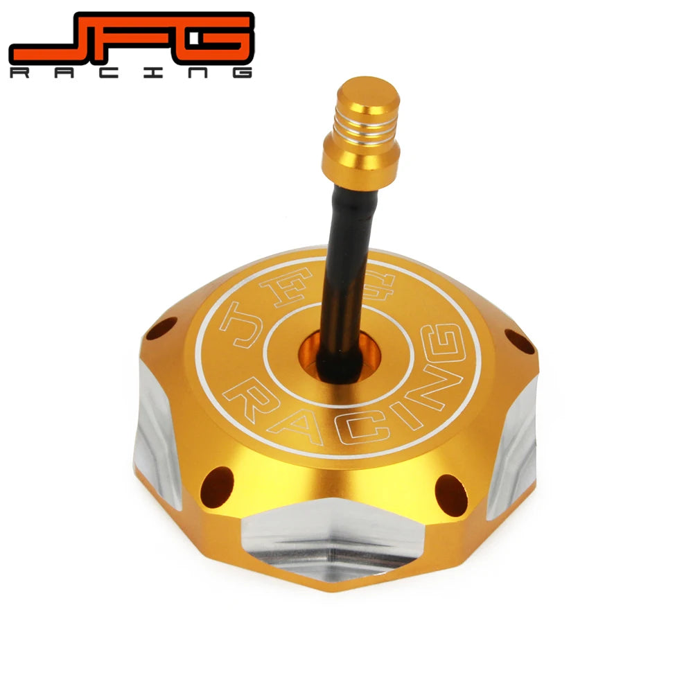 A gold-colored CNC machined fuel tank cap for a Suzuki motorcycle, featuring an threaded top and engraved text.
