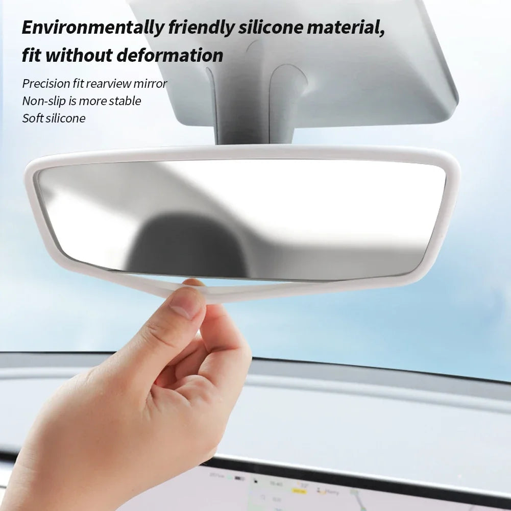 A hand is holding a white silicone rearview mirror edge protector, designed to fit without deformation.