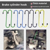 A set of brake cylinder hooks in green, blue, black, and yellow metal for suspension disc service brake caliper use.