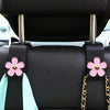 Support de tête de siège de voiture noir avec des fleurs roses et des accents bleu clair pour l'organisation