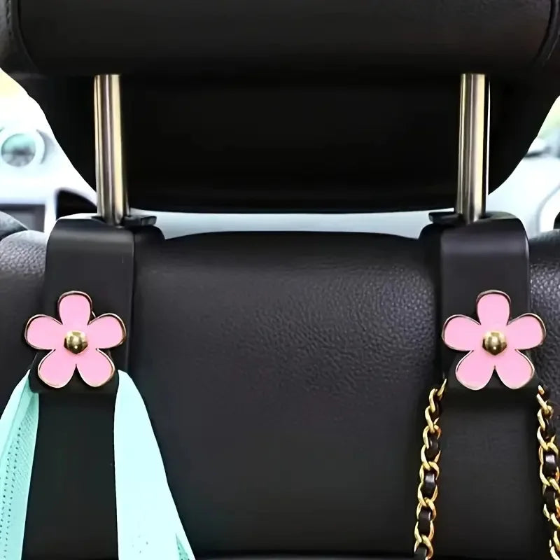 Support de tête de siège de voiture noir avec des fleurs roses et des accents bleu clair pour l'organisation