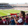 A young woman holds a red portable air horn for vehicle alarms in a stadium setting.