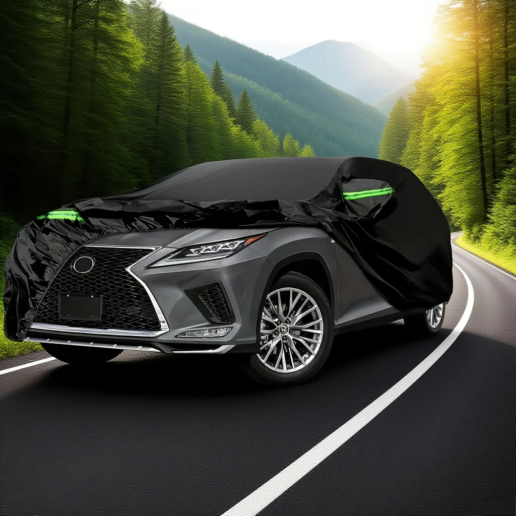 A black All-Weather Waterproof UV car cover is shown on a modern vehicle driving down a scenic, sunlit road.