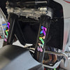 Close-up of motorcycle racing suspension components featuring colorful decals and polished metal parts.