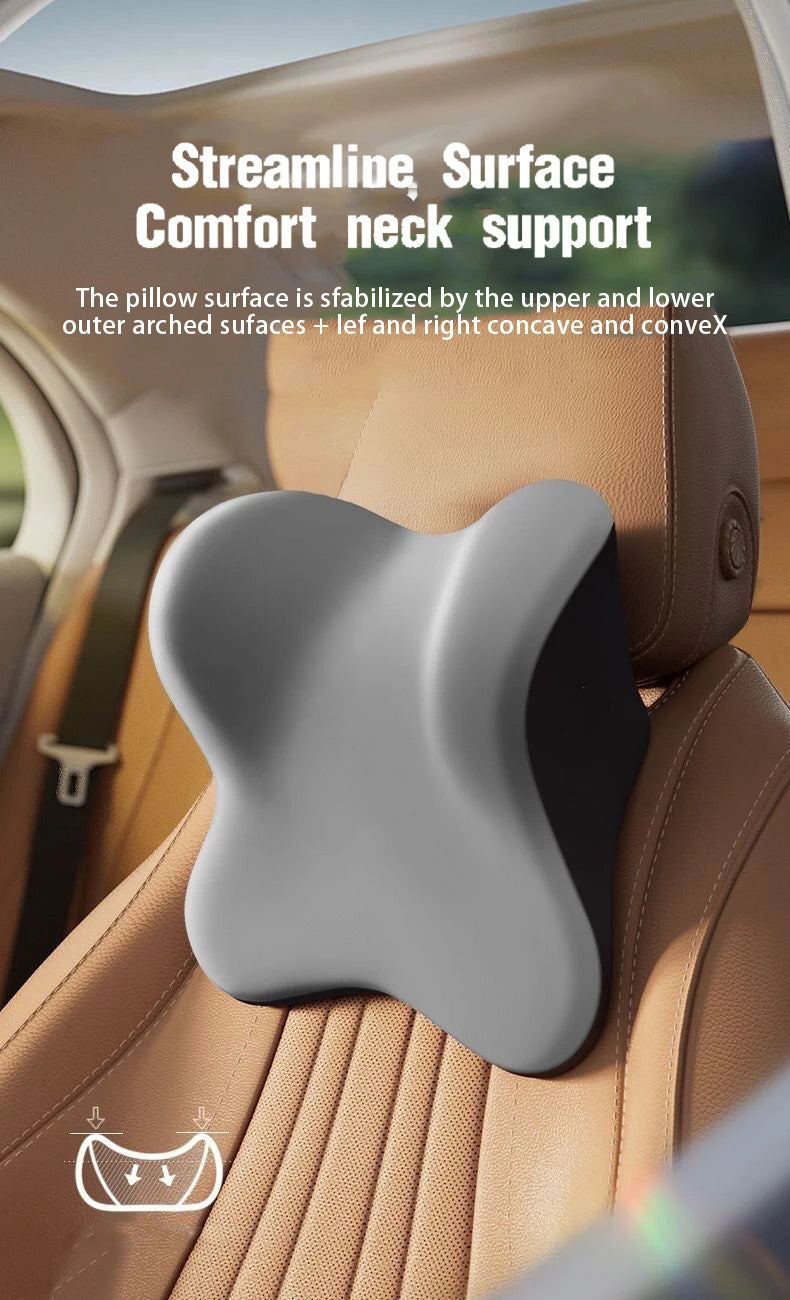 A gray ergonomic neck support pillow is shown placed on a tan car seat, highlighting its surface design.