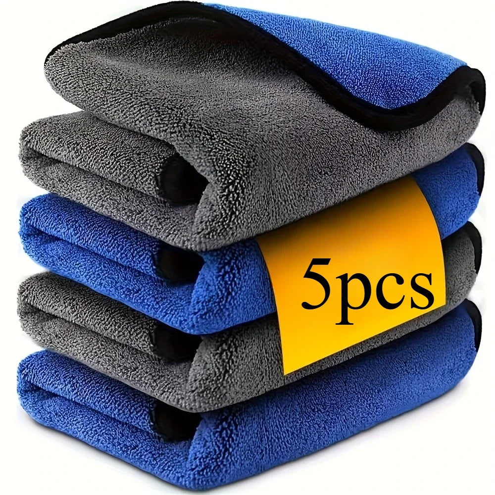 A stack of five blue and gray microfiber car cleaning towels.