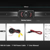A black wired backup camera is shown with its housing, lens, and accompanying cables on a dark background.