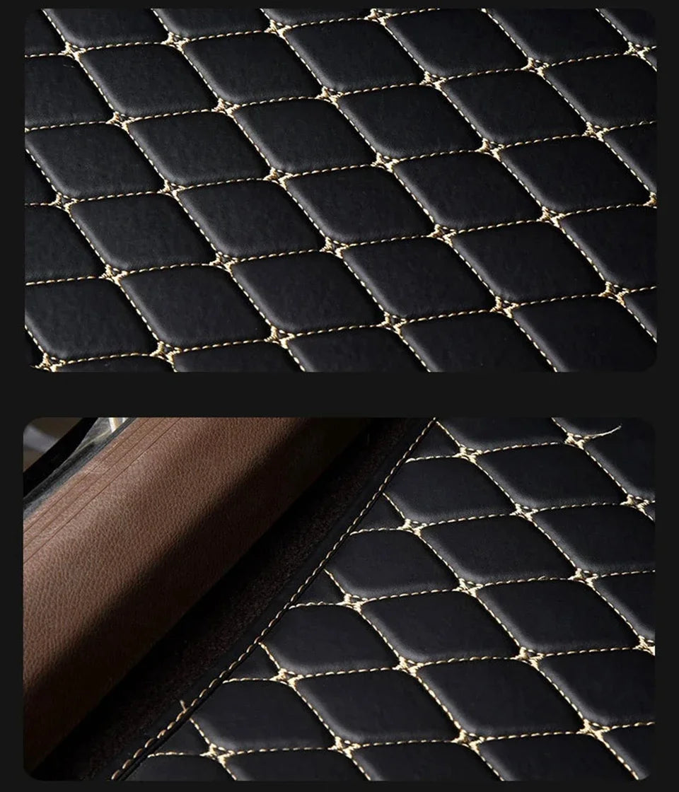 Close-up of black quilted PU leather car floor mats with gold stitching.