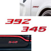 Close-up view of a white car fender with 392 and 345 decals on the side.