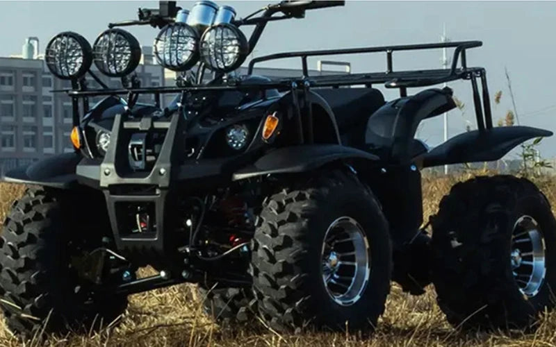 A black go-kart or ATV with a front rack and large tires is shown in an outdoor setting.