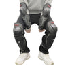Black heavy-duty motorcycle and dirt bike protection pads worn on a person's legs and feet.