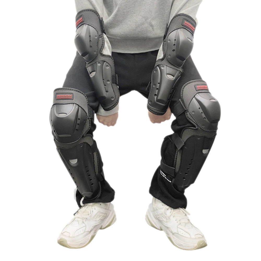 Black heavy-duty motorcycle and dirt bike protection pads worn on a person's legs and feet.