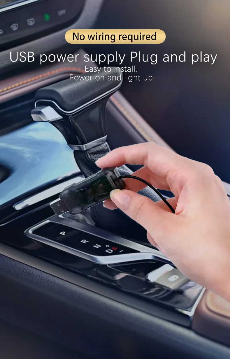 A hand plugs a USB power supply into a car interior component to light up the area.