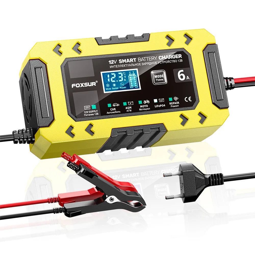 A yellow Foxsur 12V smart battery charger device with a display and cables is shown next to a battery clamp.