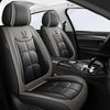 Interior view of a car with black leather seat covers and a steering wheel.