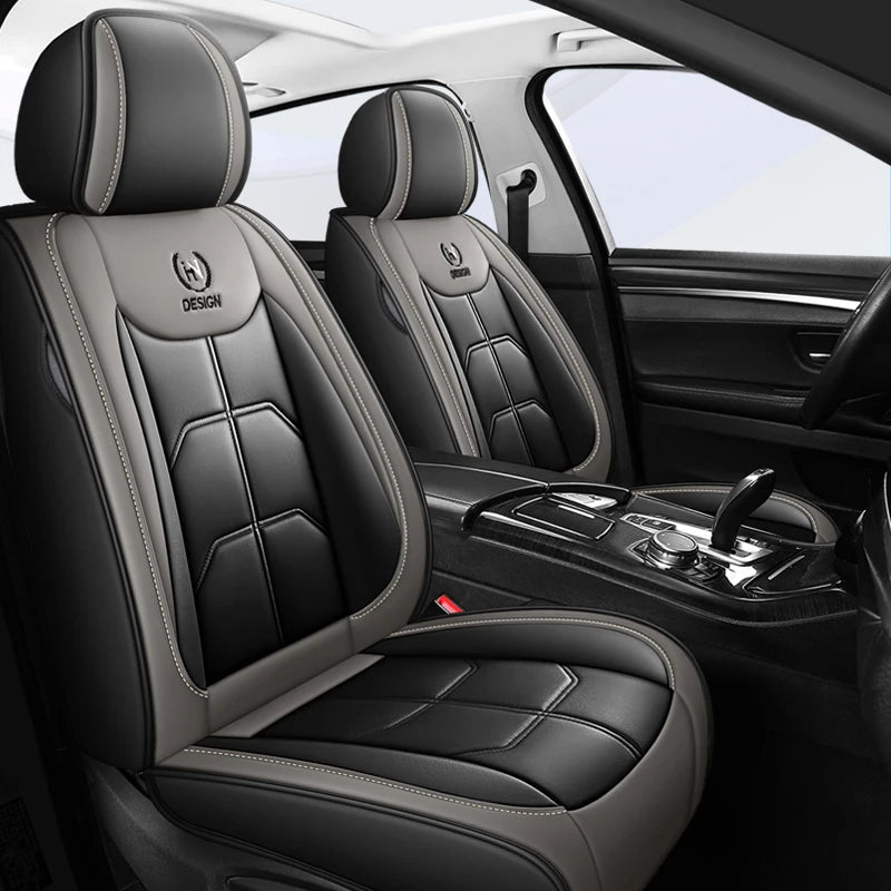 Interior view of a car with black leather seat covers and a steering wheel.