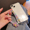 A hand holds a white smartphone with a lanyard featuring round beads in shades of pink, purple, and yellow.