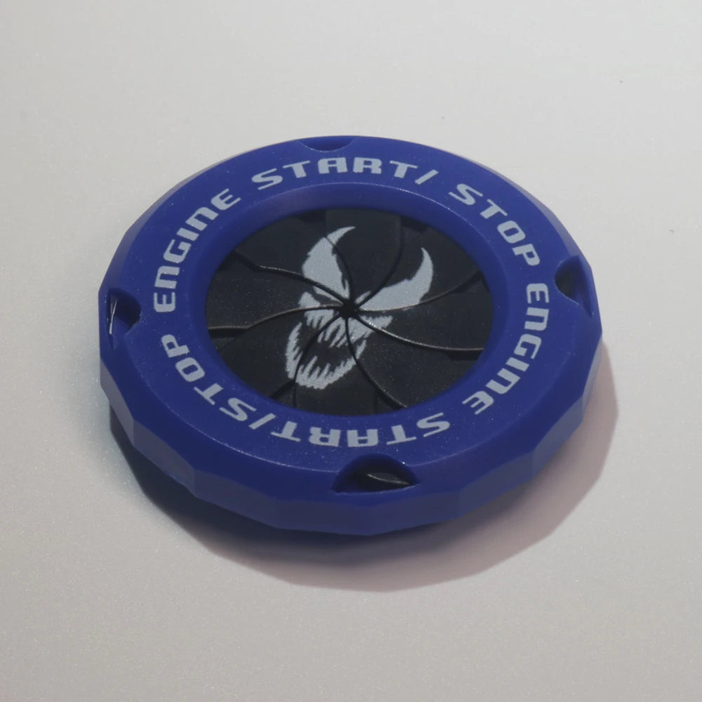 Blue decorative cover for an engine start/stop button with a white skull design.