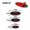 A set of six Ford car badge emblems or decals in various sizes and a red and black piece.