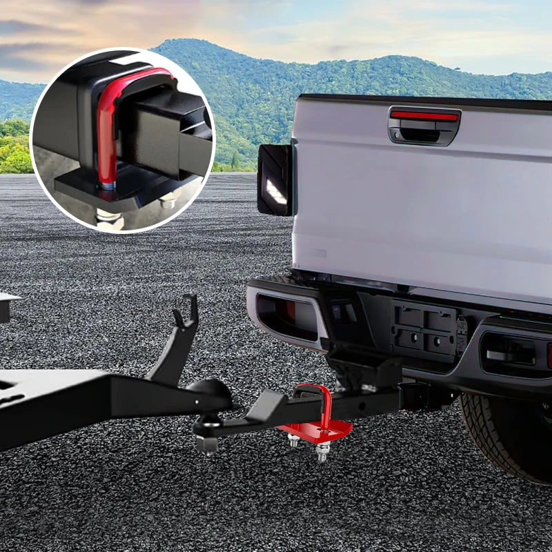 Close-up of a heavy duty trailer anti-rattle stabilizer lock mounted on the rear of a white truck.