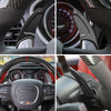 Close-up view of a CNC aluminum steering wheel paddle shifter and various automotive interior components.