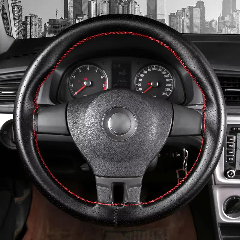 Close-up view of a black steering wheel with a leather cover, showing the dashboard and instrument cluster.
