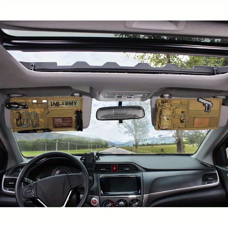 Interior view of a vehicle showing a tactical visor organizer with MOLLE pouches mounted on the roof and dashboard.
