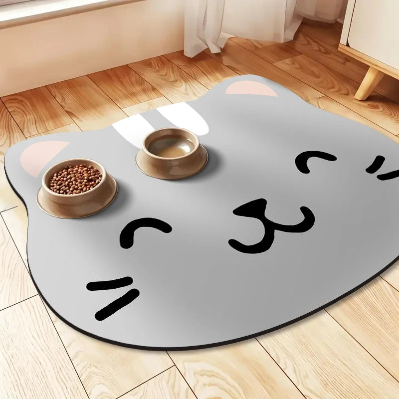 A gray mat shaped like a cat with white markings, featuring a bowl of pet food on it.