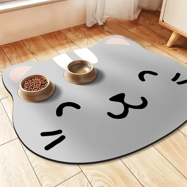 A gray mat shaped like a cat with white markings, featuring a bowl of pet food on it.