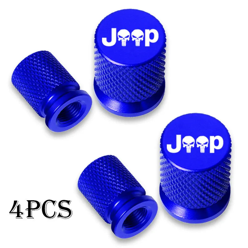 Four blue Jeep tire valve caps with textured metal bodies and skull designs