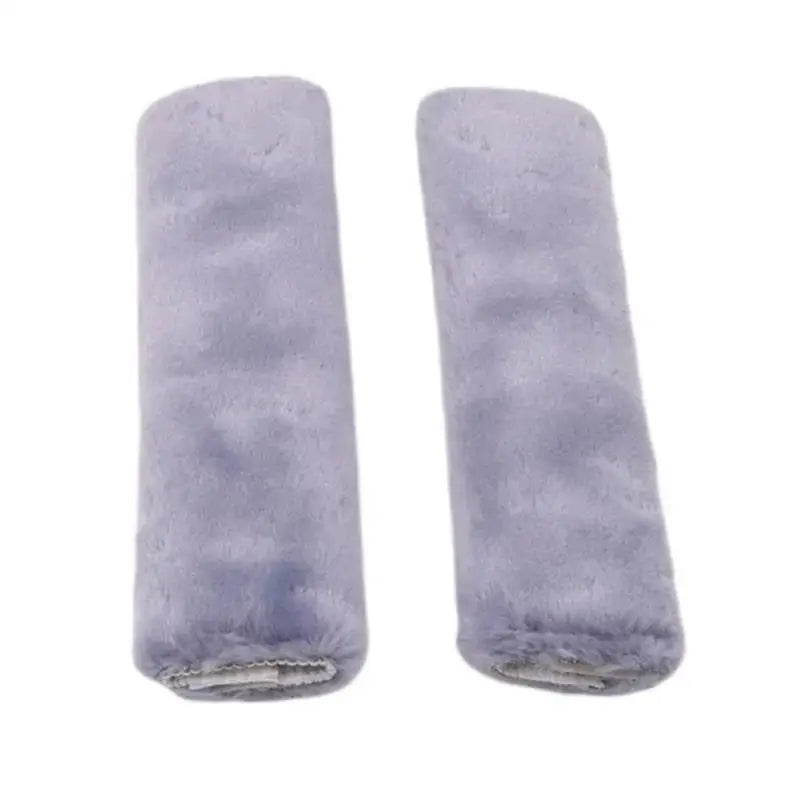 A pair of light purple luxury car seatbelt shoulder pads.