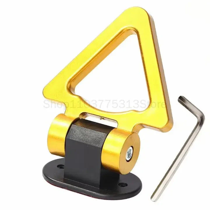 A gold-colored decorative racing tow hook sticker with a black mounting base and metal hook.