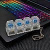 A clear plastic keychain featuring multiple clickable LED keyboard fidget toys attached to a silver chain.