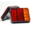 Dual high-brightness truck tail lights with red and amber lenses mounted on a black bracket