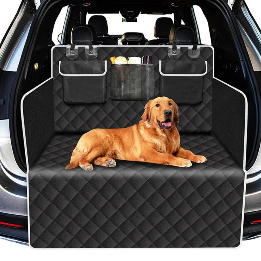 A golden retriever lies comfortably in a black pet trunk liner installed in the back of a car.