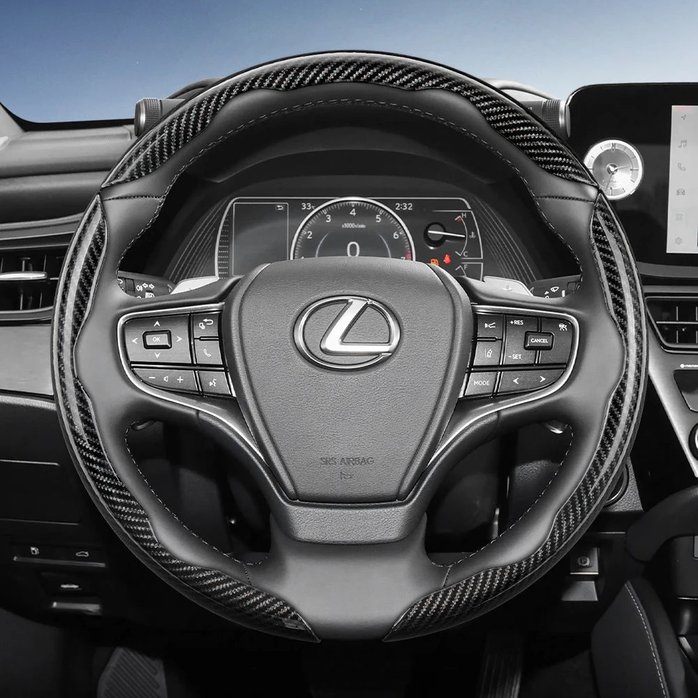 Close-up view of a Lexus steering wheel with carbon fiber trim and controls.